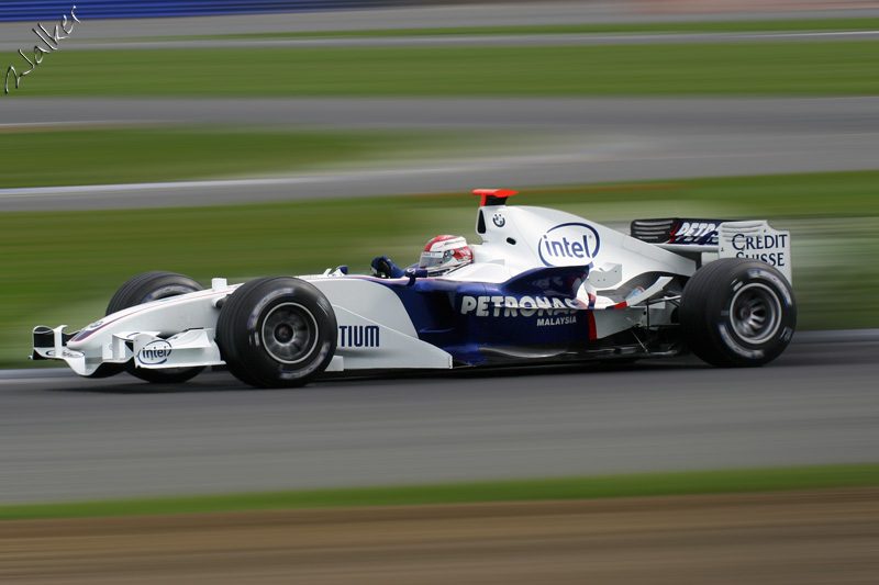 BMW Zoom
Okay, this is probably Wurtz in his Williams that has been edited. I cut out the car, blurred the background, pasted the car back on and blurred the wheel hubs.

Thats it! 
Keywords: Williams Cosworth F1 Silverstone