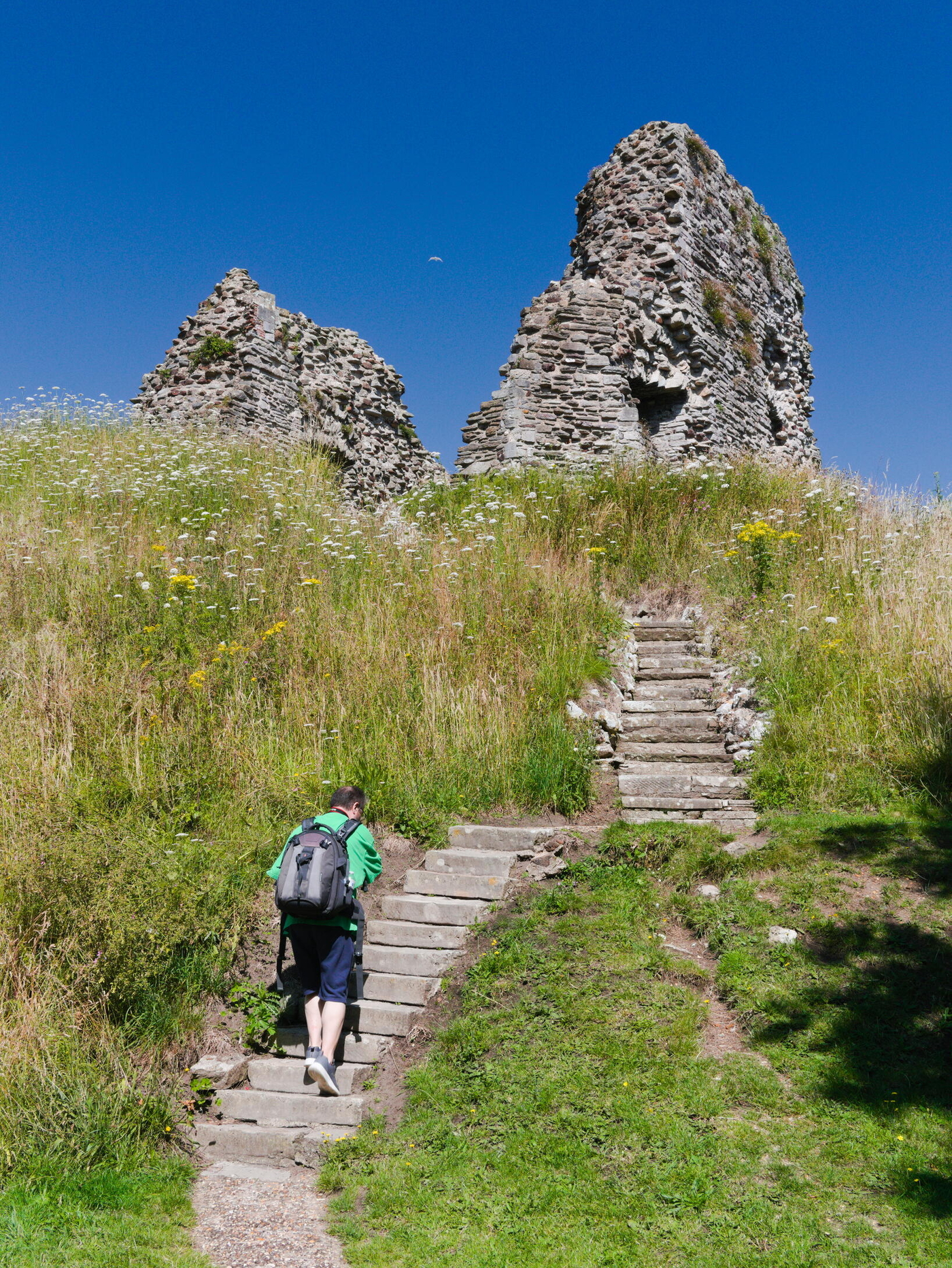 A man walking up steps to the Norman Keep, Christchurch
